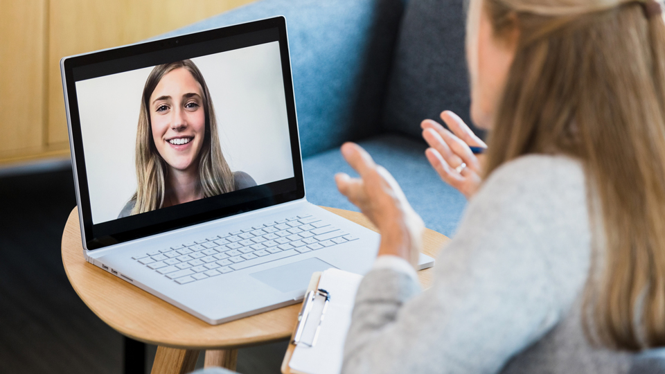 A woman has a video consultation with a female clinician