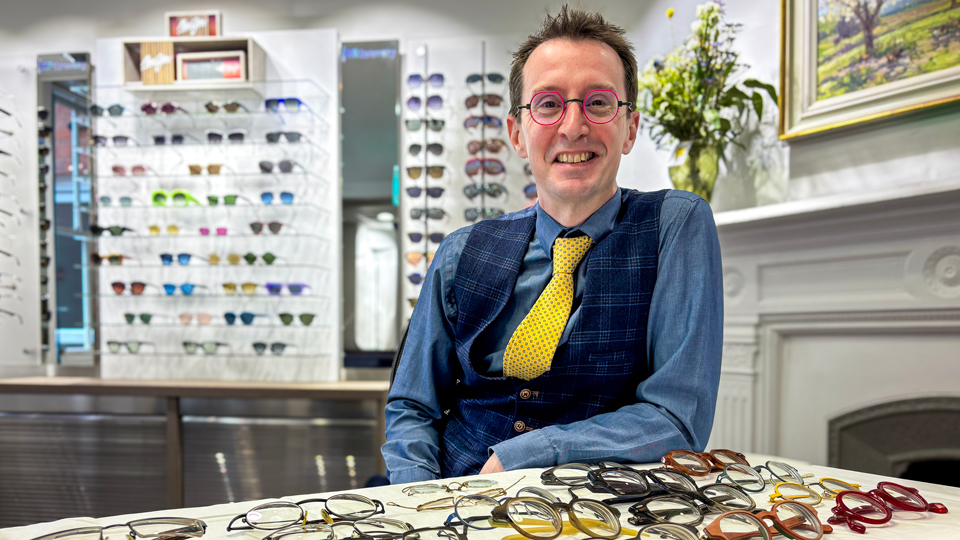 Daniel Read at BBR Optometry with his collection of spectacles arranged in front of him