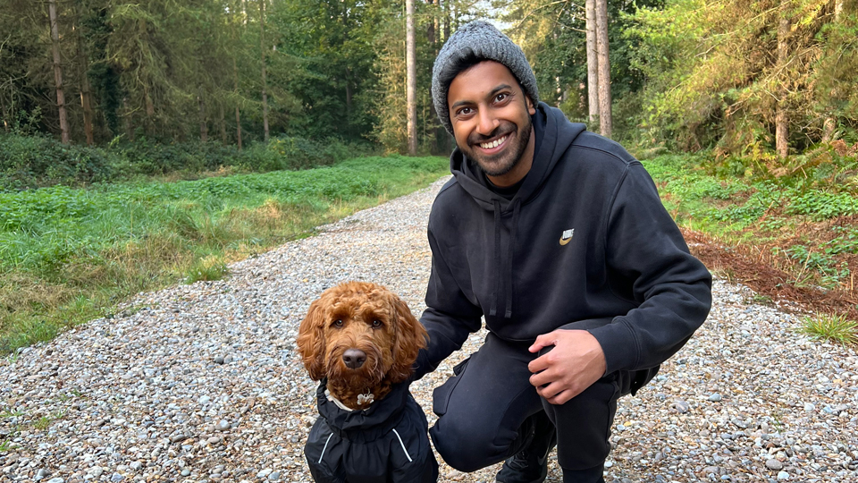 Akshay Shah is shown with his dog who is wearing a matching outfit
