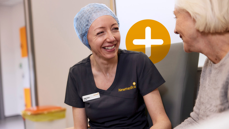 Newmedica employee smiling with a patient