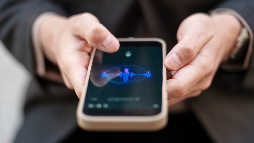Hands showing a phone recording audio