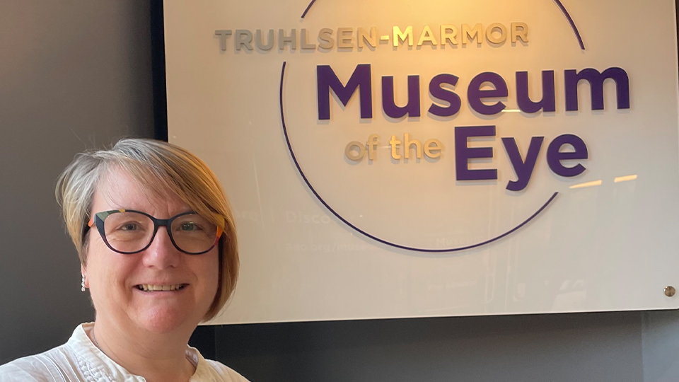 Sarah in front of the sign for the Museum of the Eye