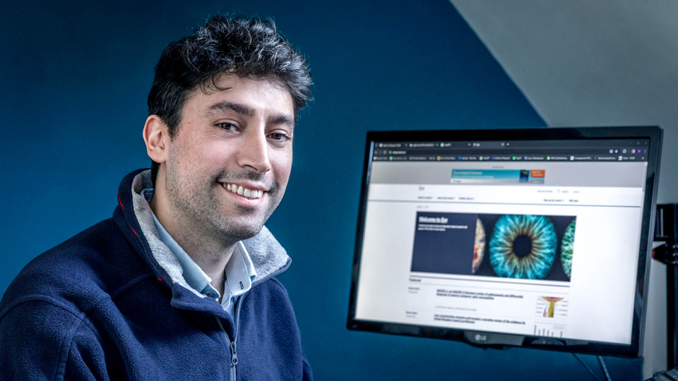 The Macular Society’s director of research, Dr Peter Bloomsfield sitting at his laptop