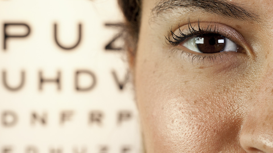 Close up of an eye with a test chart in the background