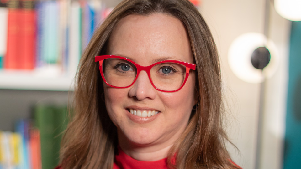 Ceri smiling in a red top