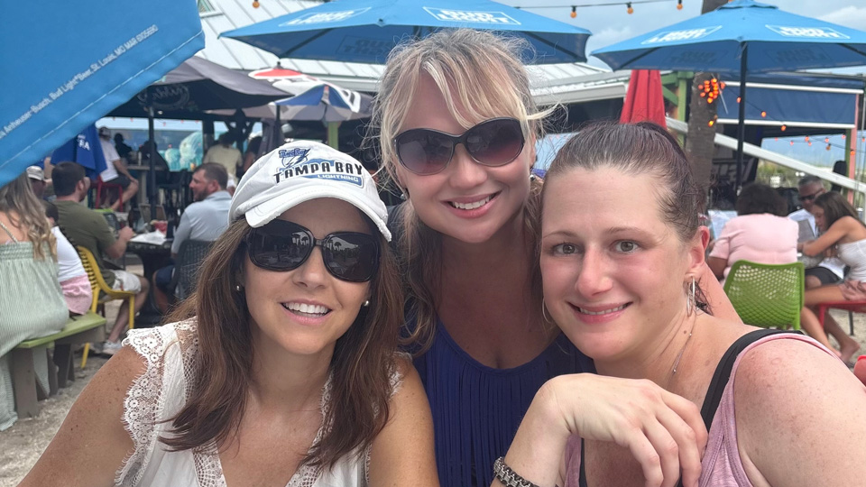 Dr Valarie Jerome relaxes with friends at an outdoor restaurant
