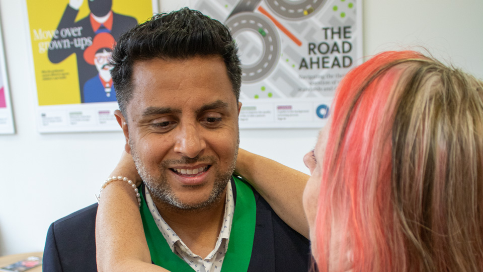 Nizz Sabir receiving the AOP chairman medal from Emma Spofforth