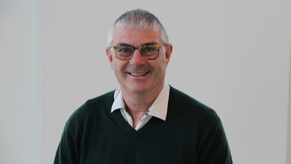 Garrey is smiling in a blue shirt