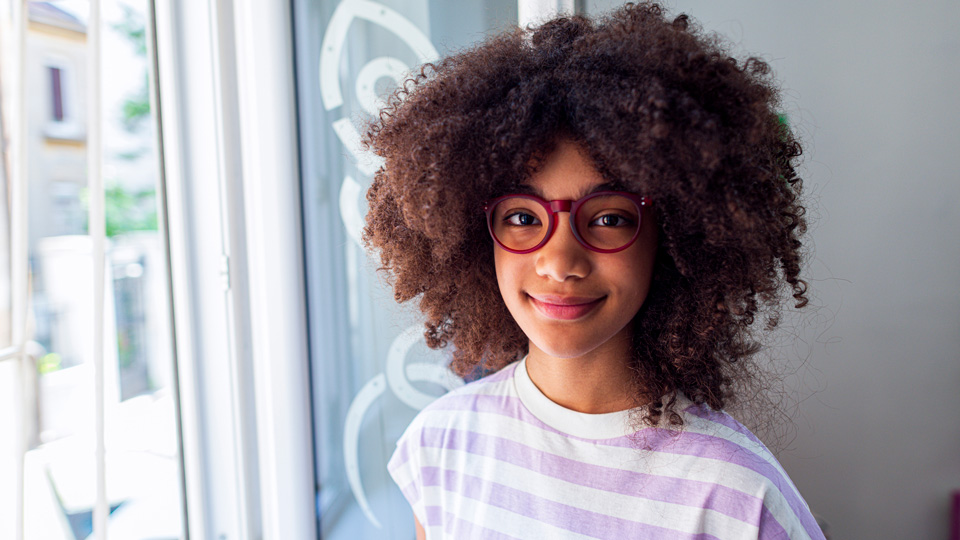 A portrait photo of a girl wearing glasses