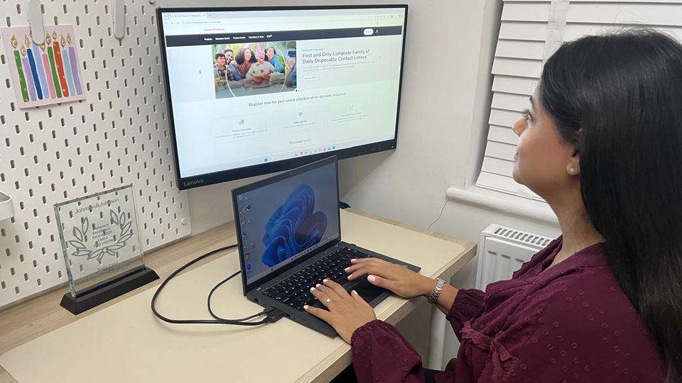 Risha Patel sitting at a desk working from home