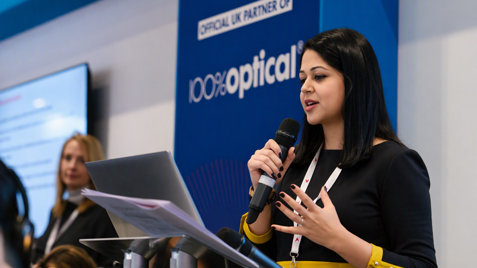 Risha Patel speaking at 100% Optical