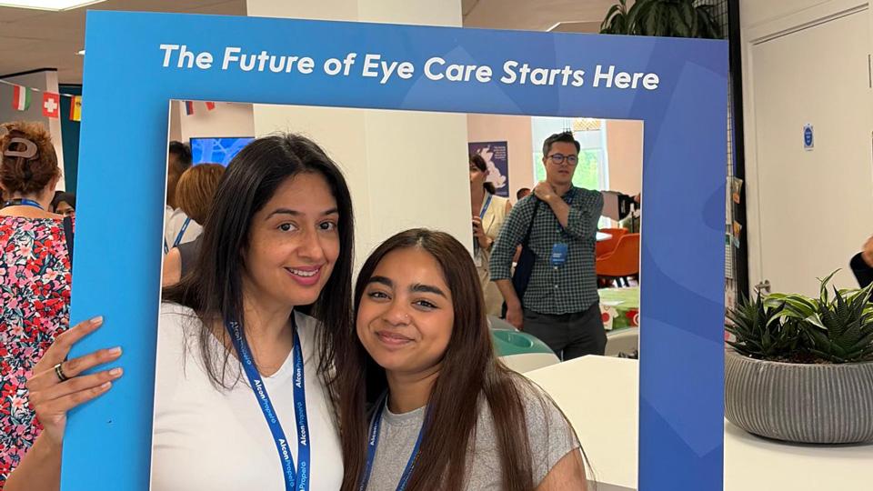 Shahana Miah standing with an Alcon Propel cardboard frame