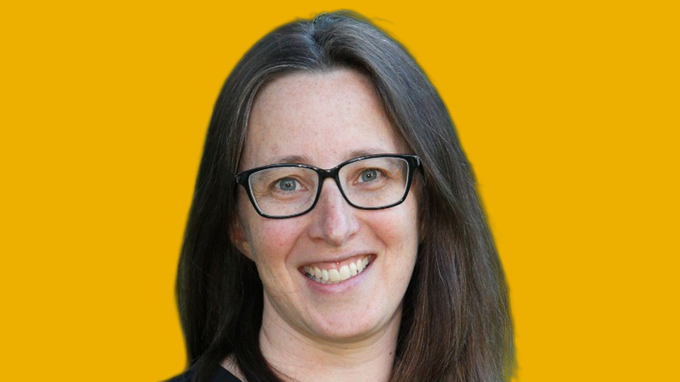 An headshot style photograph of Jude Stern cut out on a yellow background
