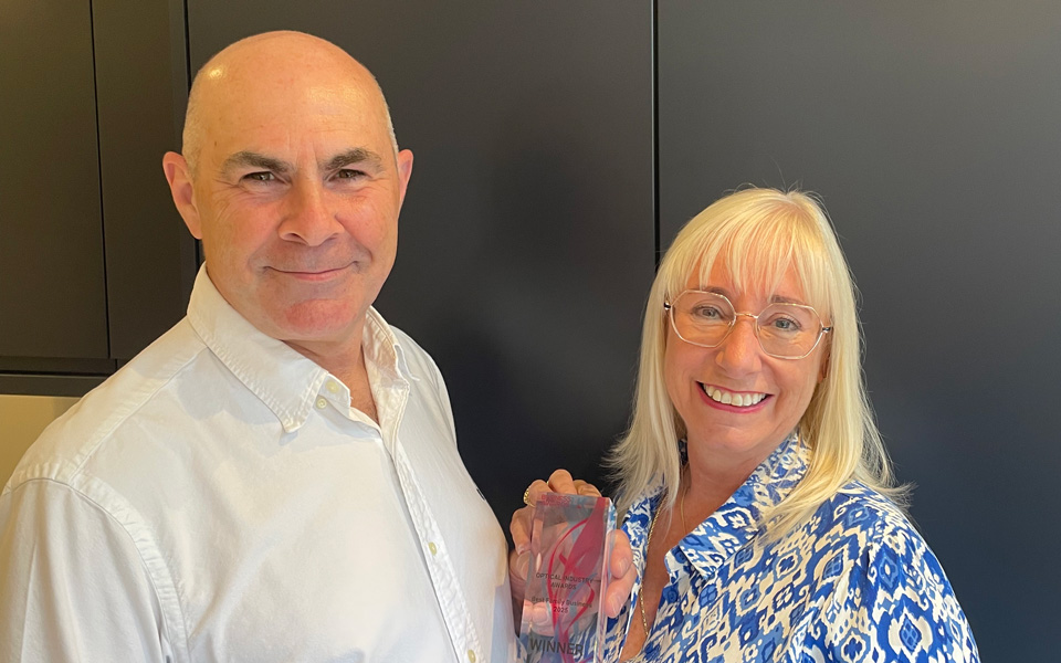 Alan and Tracey Bellamy hold a glass trophy between them