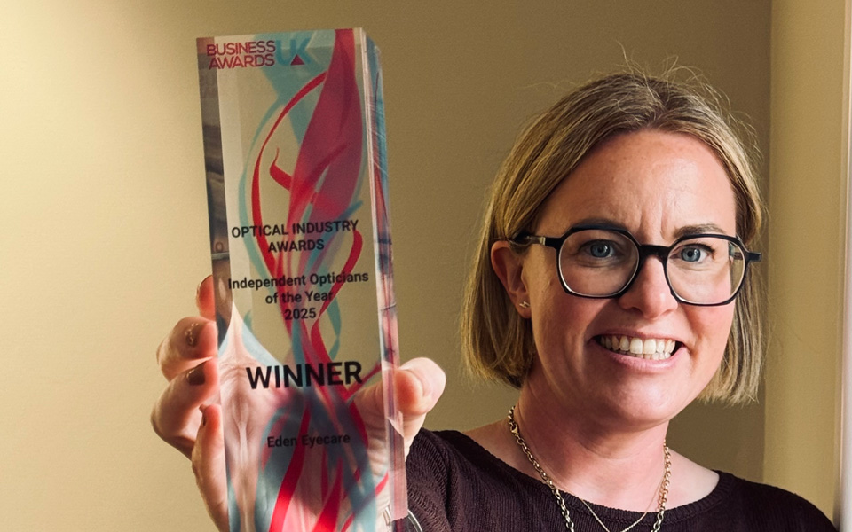 Zoe holds up a glass trophy