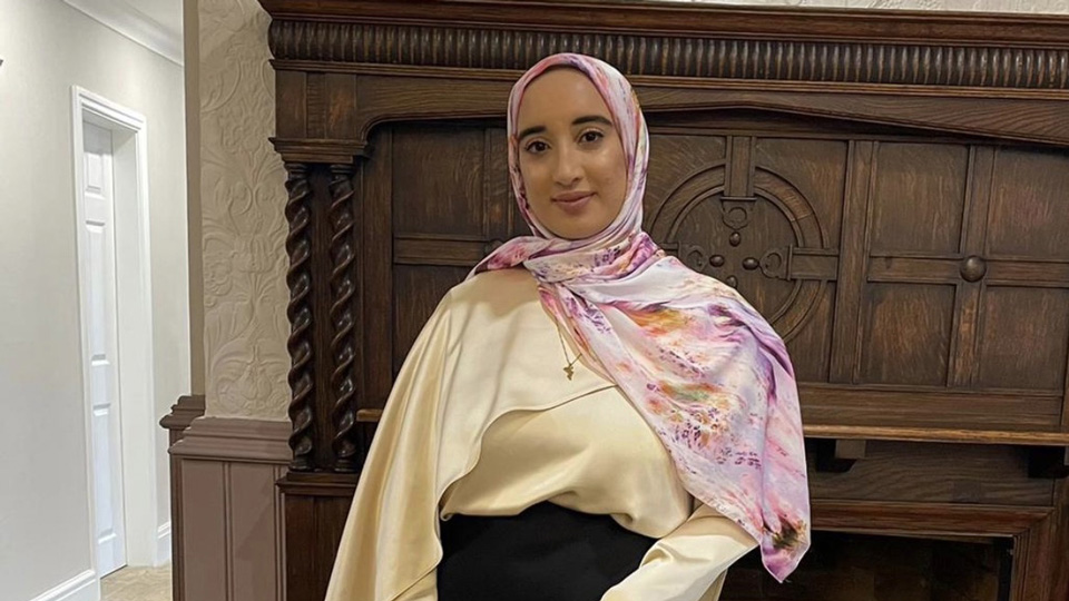 Nadirah Talati is shown in a pink pattern hijab and white longsleeved top