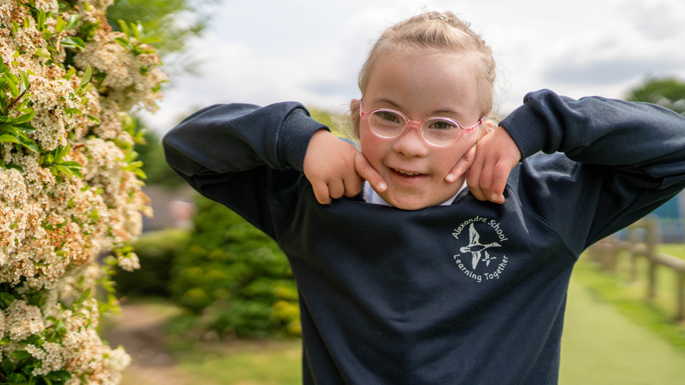 Ellie smiles broadly in her glasses