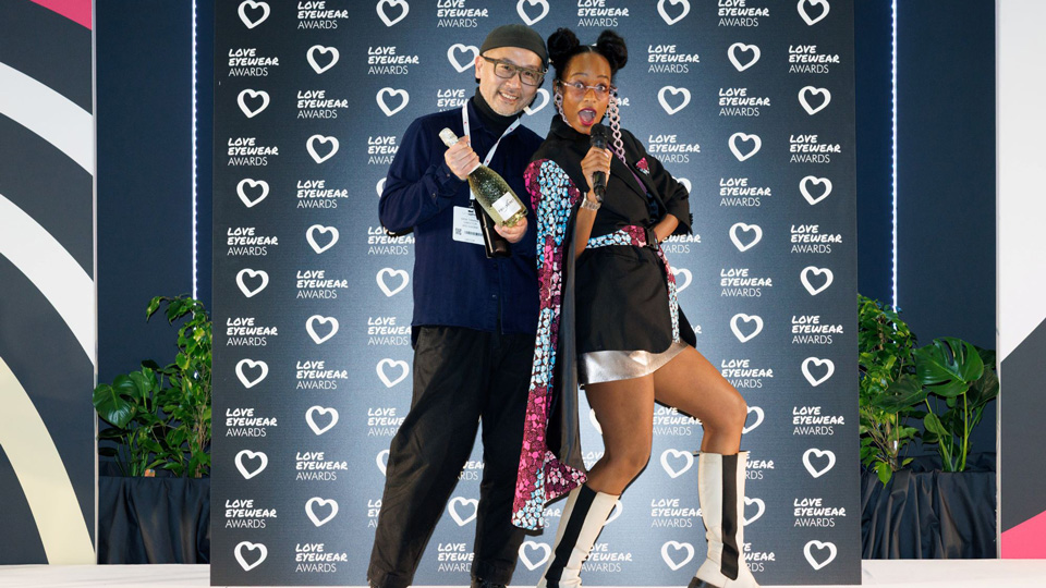 A presenter and an award recipient on stage