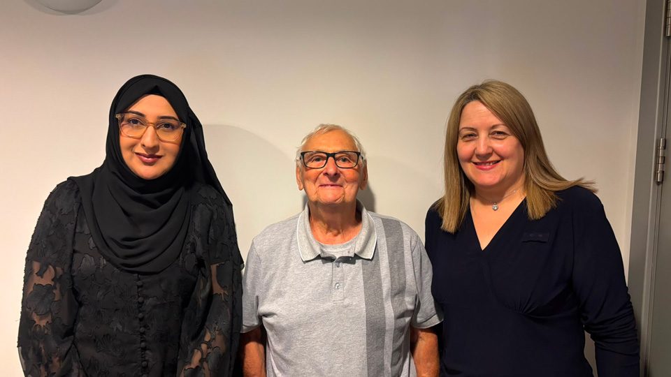 Edwin Causey centre with Specsavers staff members all smiling at cameras