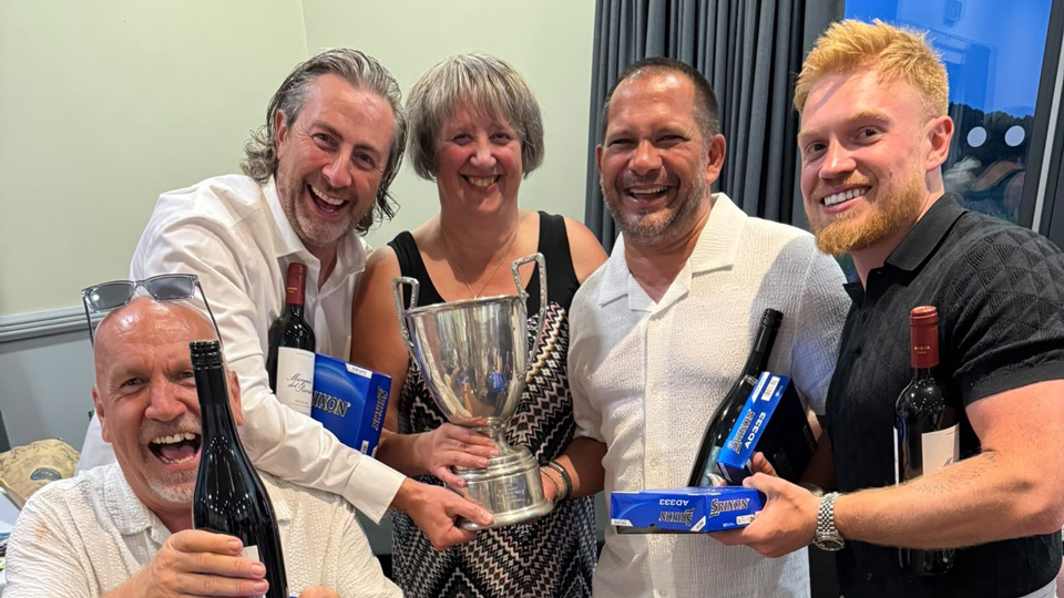 Optical Suppliers Association members collect their golf trophy from Debbie White