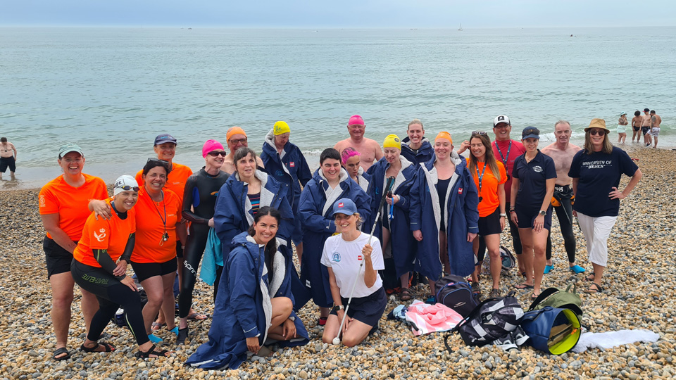 Swimmers gather at the water’s edge during the Gateway to the Sea event