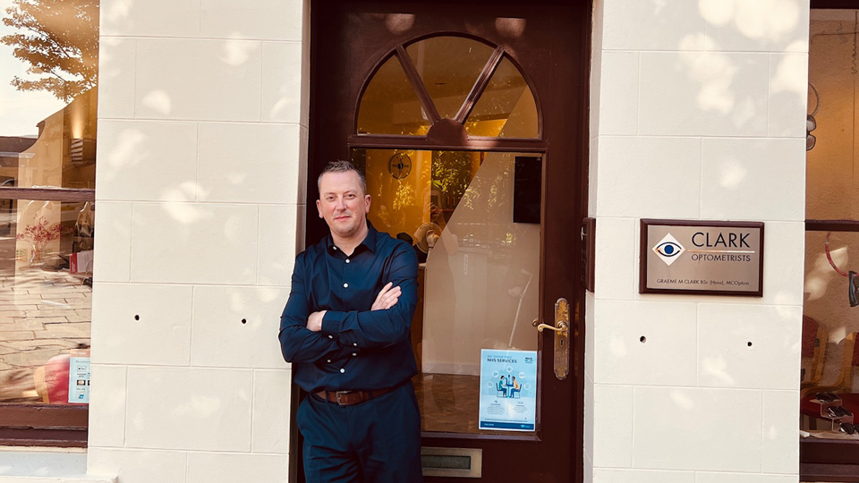 Optometrist, Andrew Gillies, in front of Clark Optometrists on Orkney Island