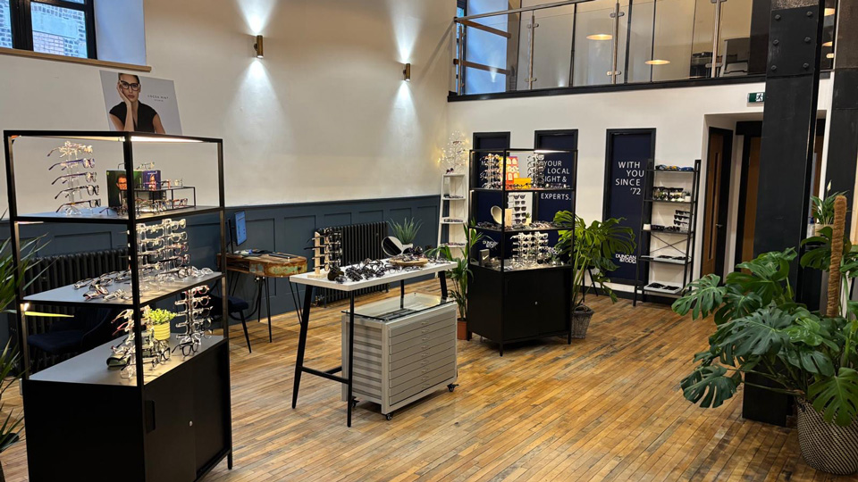 The inside of an optometry practice with high ceilings and a mezzanine floor