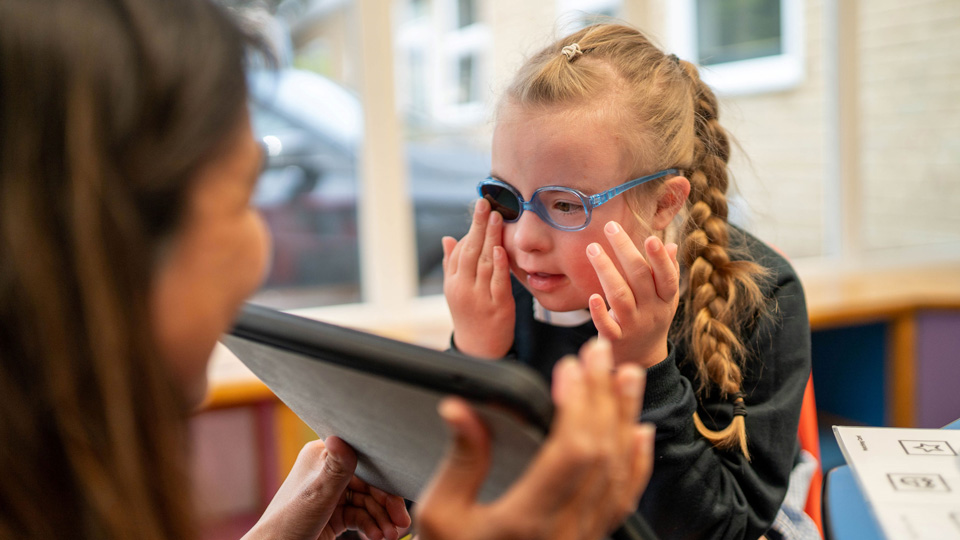 Little girl getting a sight test with blue glasses 