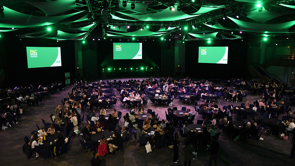 A birds eye view of delegates in a conference hall sitting for a lecture at PAC 2025