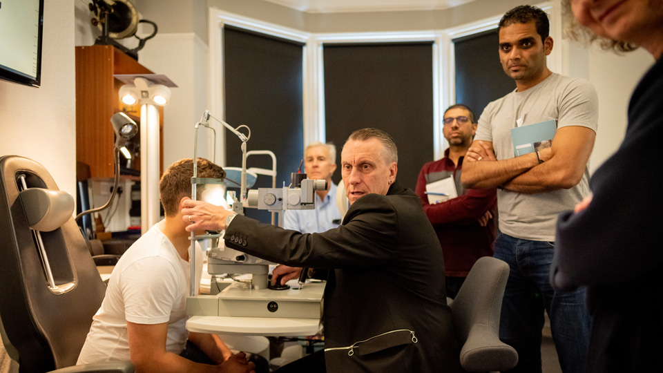 Brian is performing a sight test in a room full of onlookers