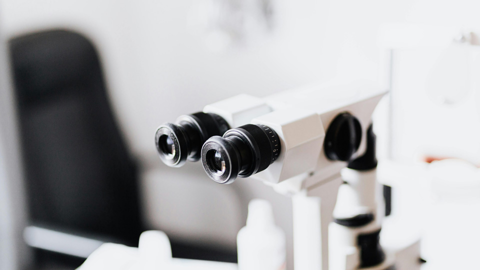A close up of the view finder of a piece of optical equipment in a consulting room