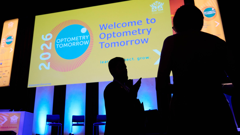The silhouette of delegates before the stage at Optometry Tomorrow