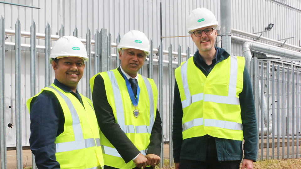 Shafi Ahmed, Shazu Miah and Paul Robinson in high visibility jackets with a spade at the beginning of Kidderminster expansion Specsavers project