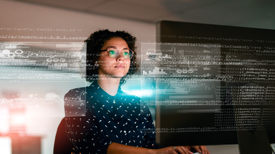 A computer programmer works in front of a screen