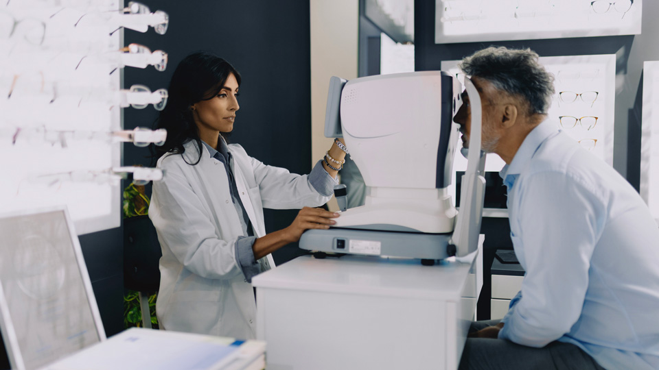 Female optometrist using an OCT machine on a patient in practice