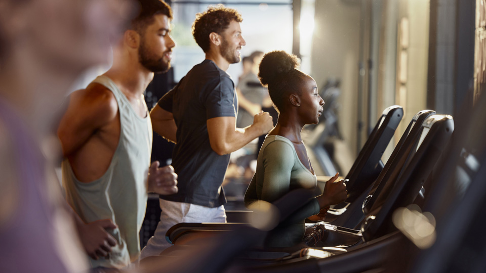 Gym goers exercise on treadmills