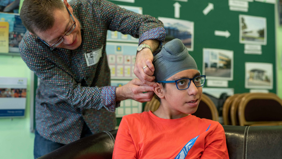 Martyn dispensing glasses to a pupil