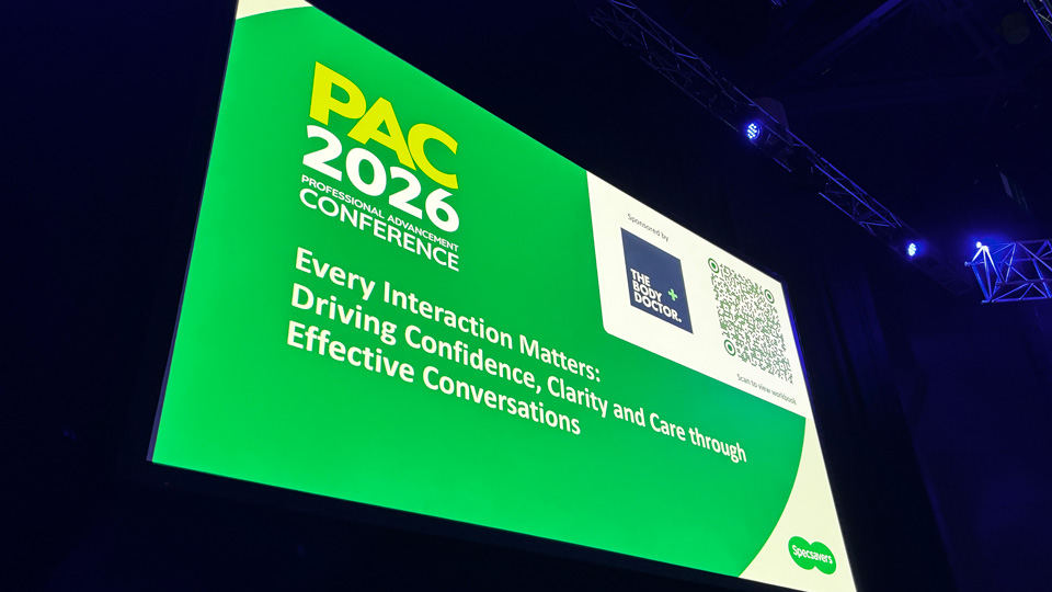 A large presentation screen of a green powerpoint slide announcing the title of the session on the importance of interactions