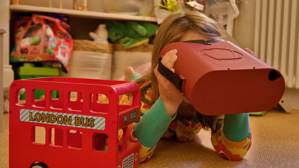 Child laying on floor using OCT device