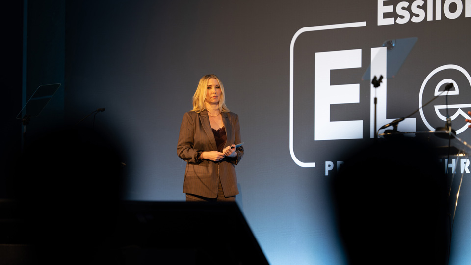 Ewelina Kawnik, marketing director for northern Europe at EssilorLuxottica, presents on stage