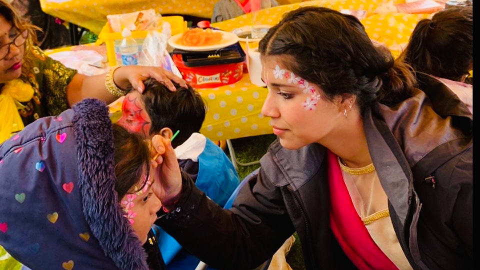 Dhruvi Valla volunteers at a face painting tent as part of Janmashtami celebrations at Bhaktivedanta Manor in Watford