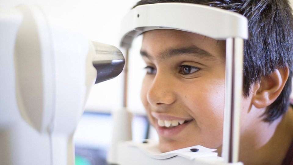 A young boy receives an eye test
