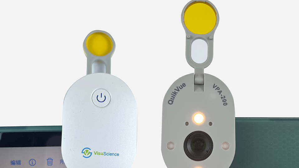 A clip has been attached to the camera of a smartphone. One is positioned facing the viewer, and the other displays the back of the tool which has LED lights switched on 