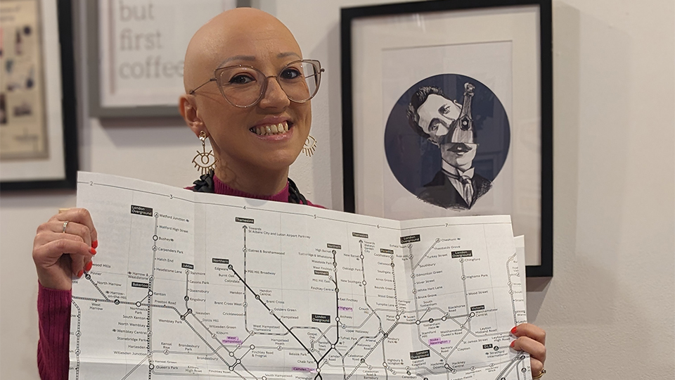 Morena holds up a large tube map