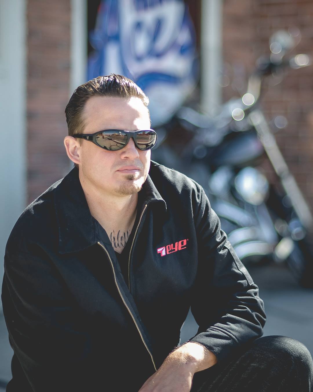 A man wears dark sunglasses