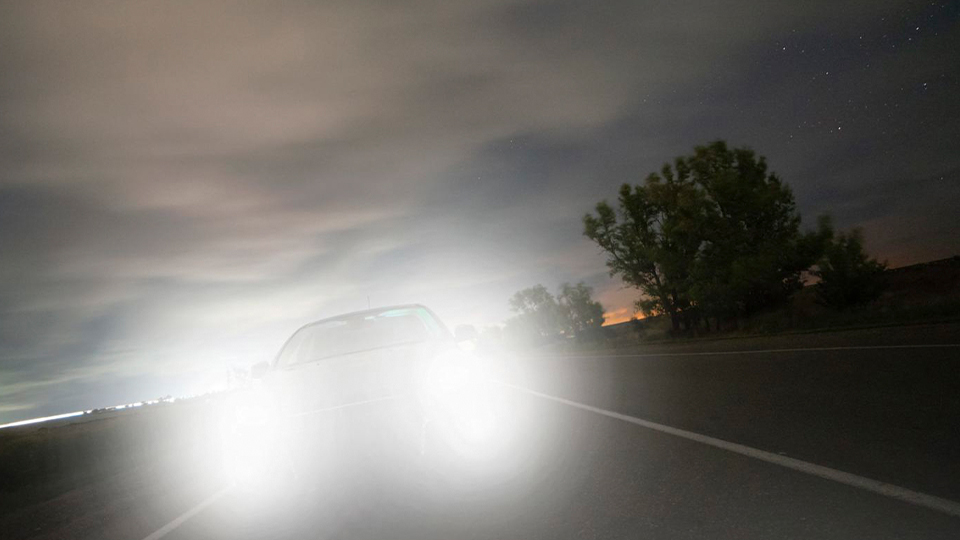 Car headlights obscure the frame