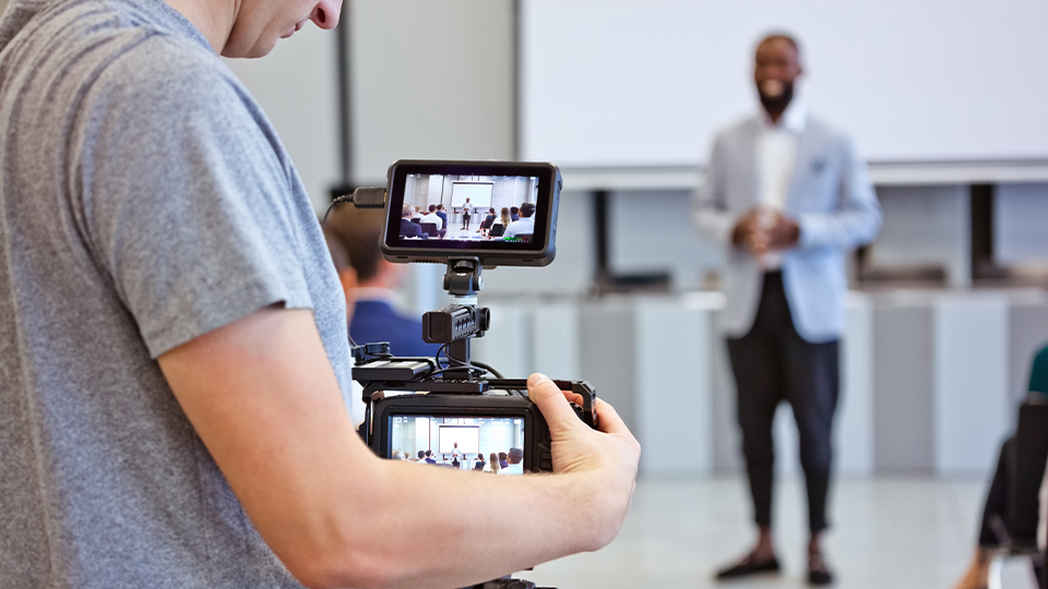 Person holding a video camera filming