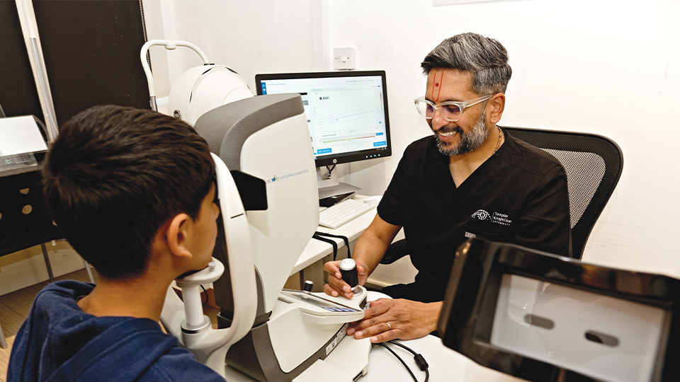 Dr Keyur Patel performs an eye examination with his son, Yush Patel