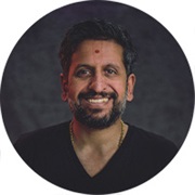 Keyur smiling at the camera in a blue t-shirt