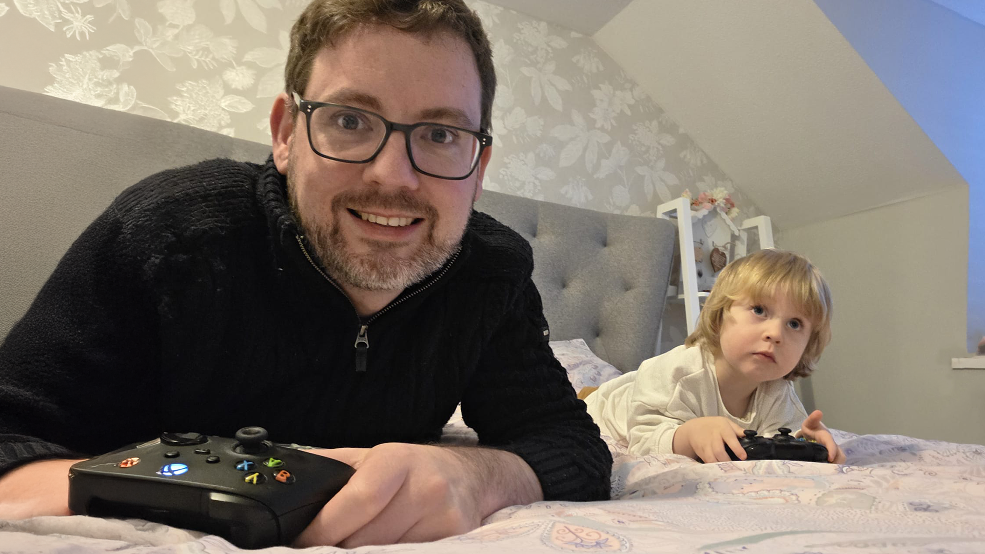 Optometrist, Jason Searle, plays a video game with his three-year-old son, Arthur